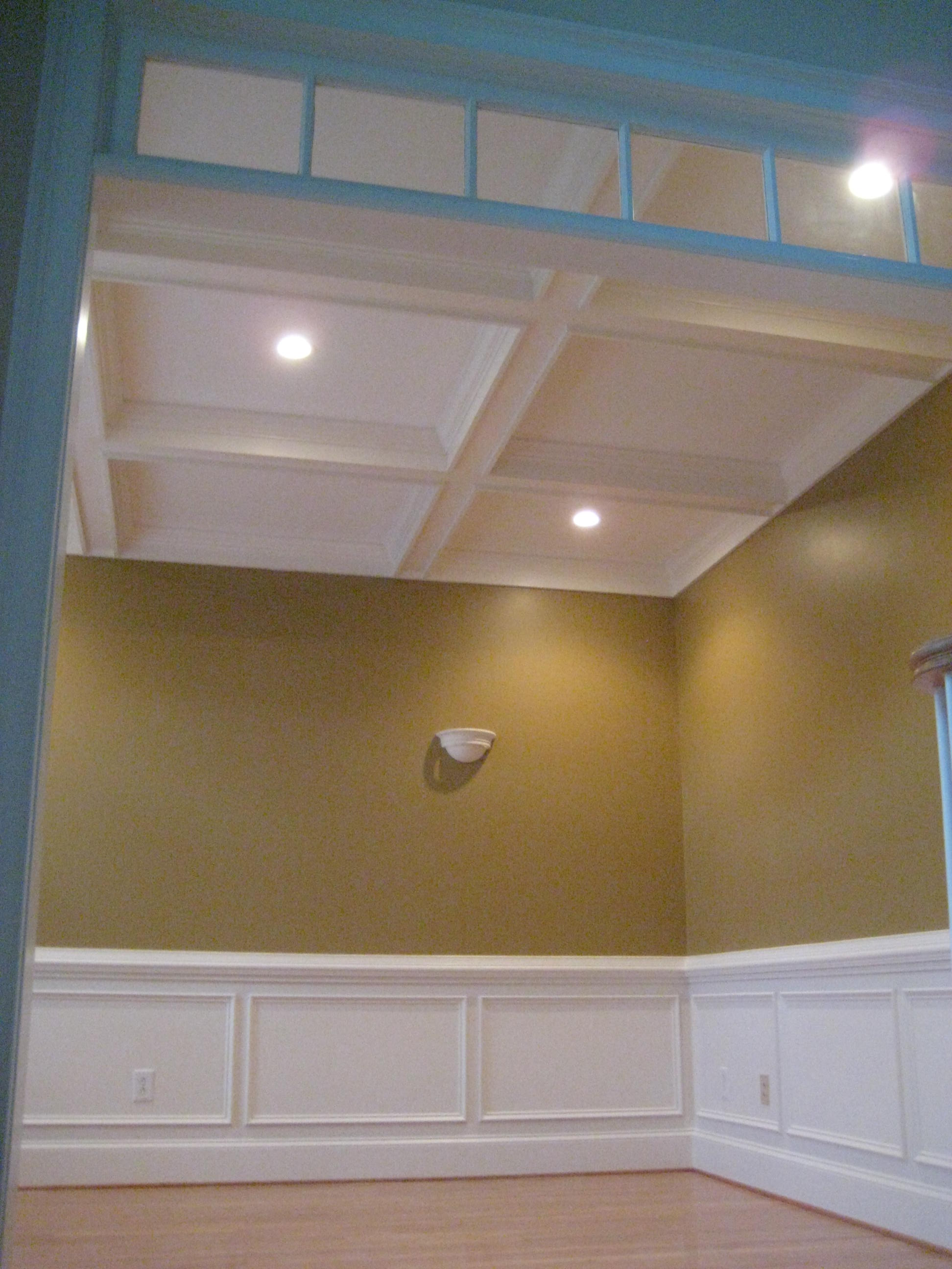 Remodel Living Room wall light sconces enhance coffered ceiling.